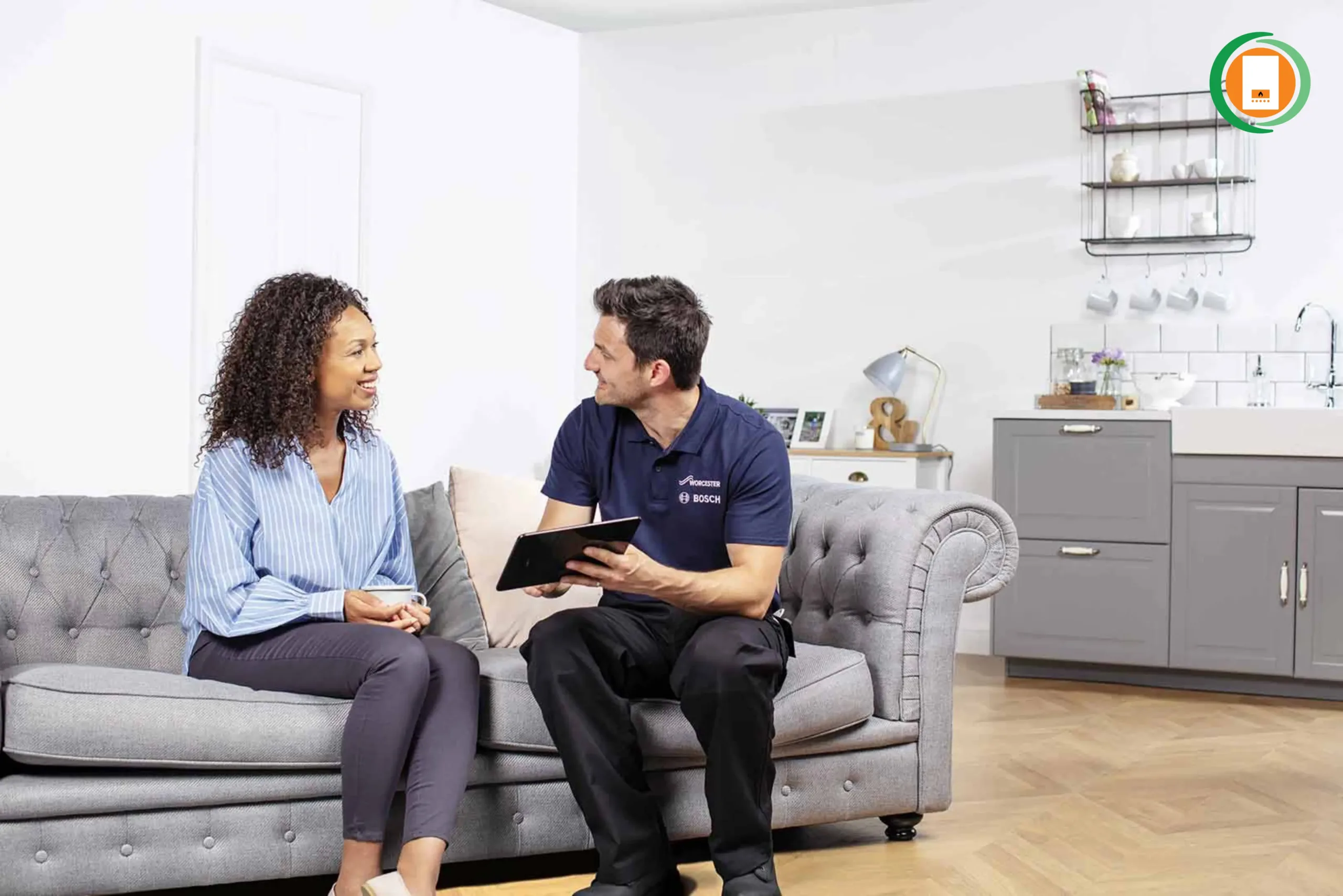 Energy advisor in company uniform discussing documents with homeowner on living room sofa, showing tablet with ECO4 eligibility checklist